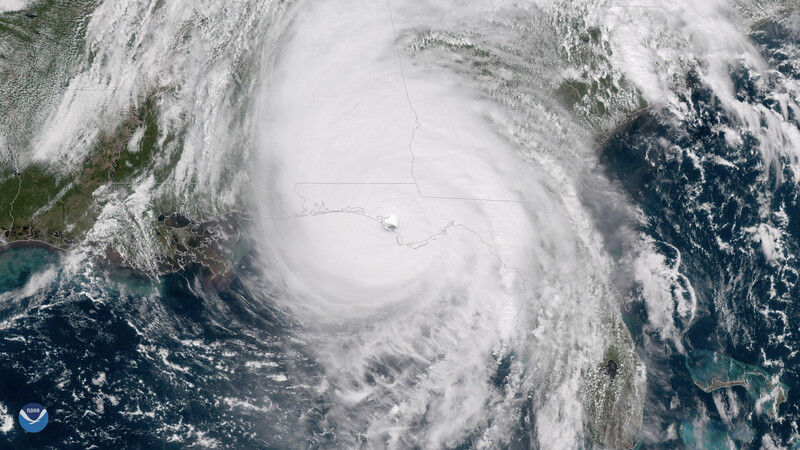 Satellite imagery of a hurricane with a defined eye and spiral cloud bands over ocean