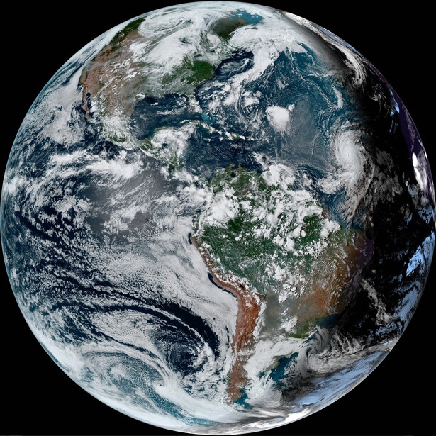 Satellite photograph of Earth showing North and South America with cloud formations and ocean swirls