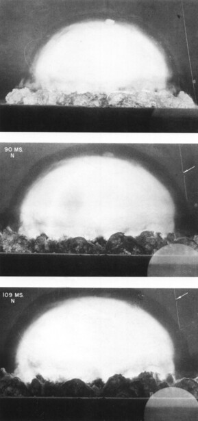 Three sequential frames of a nuclear explosion mushroom cloud expanding against dark sky