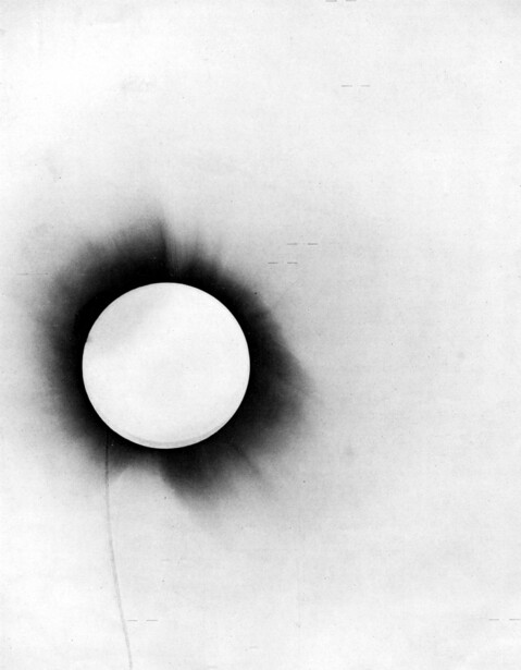White circle surrounded by dark vignetting and radiating blur