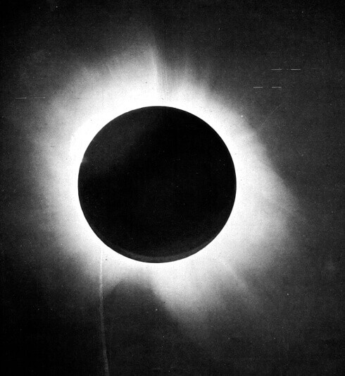 Total solar eclipse showing moon silhouette against bright solar corona