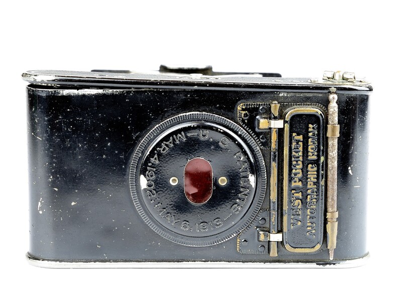 Vintage rangefinder camera with black metal body and circular lens assembly