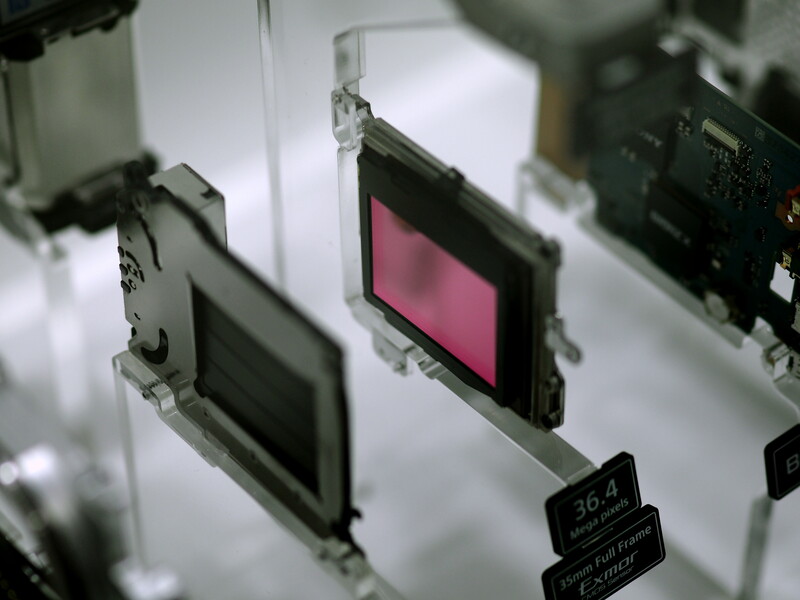 Display panel samples mounted on clear acrylic showing black and pink LCD screens with technical specifications labels