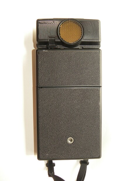 Vintage Olympus camera with detachable flash unit and leather carrying case