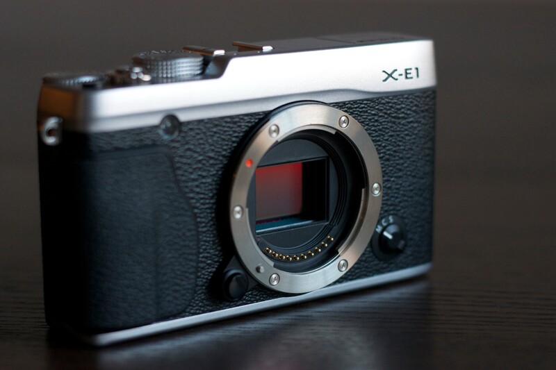 Fujifilm X-E1 mirrorless camera body displayed against dark background