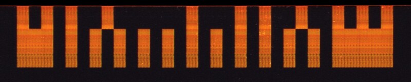 Graphic illustration of a pixel art cityscape with orange buildings against a black background