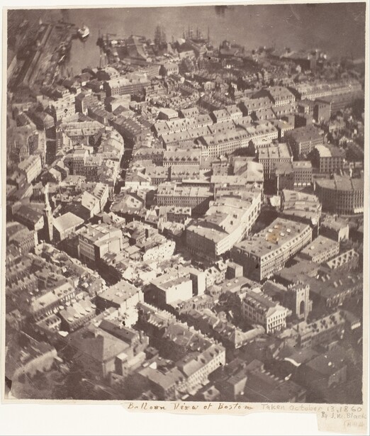 Aerial photograph of dense urban cityscape with tightly packed buildings and streets