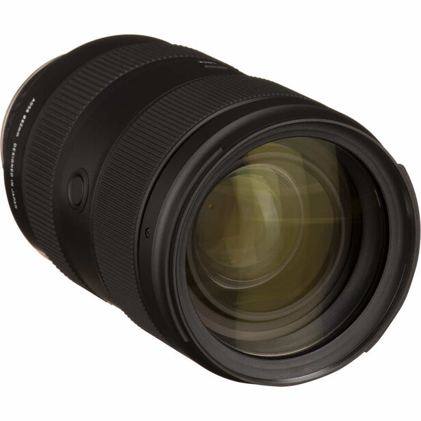 Black telephoto zoom lens with golden internal glass elements visible through the front