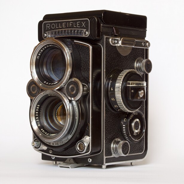 Rolleiflex twin-lens reflex camera shown front and side view against white background