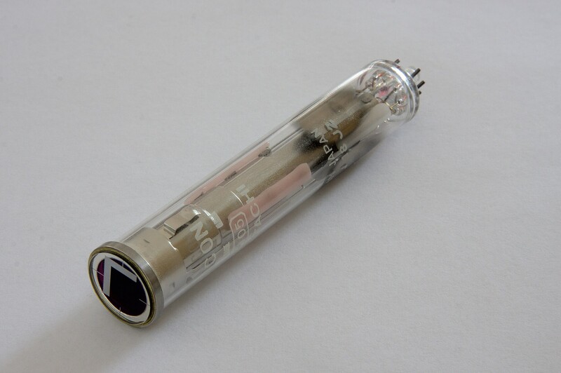 Vintage vacuum tube against neutral gray background