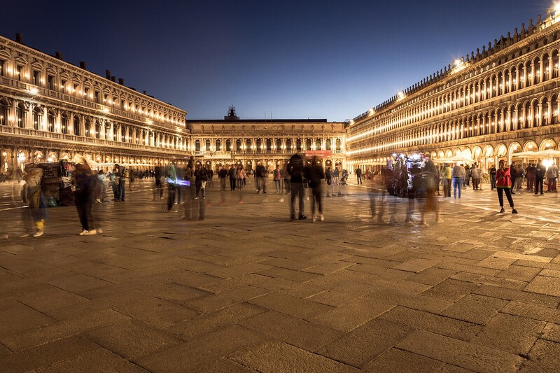 Evening cityscape of an Italian plaza with Renaissance architecture and soft golden lighting