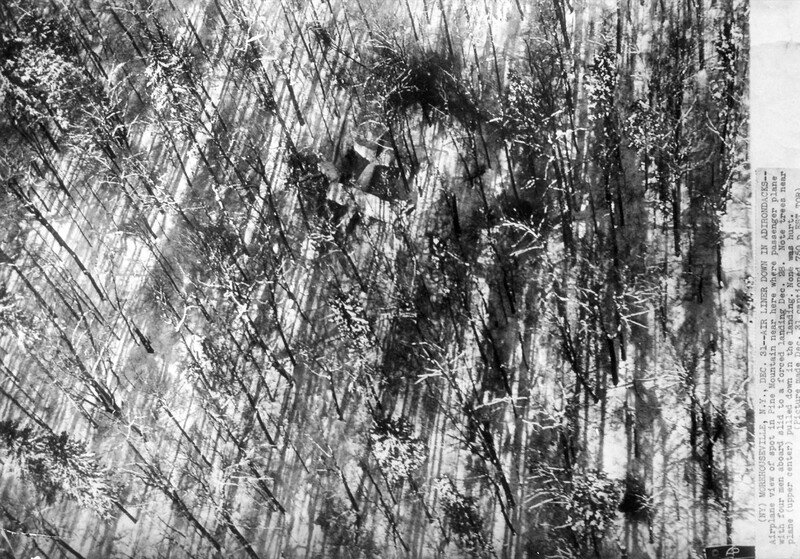 High-contrast black and white abstract composition with intersecting diagonal lines and organic textures