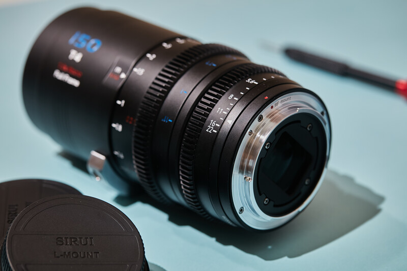 Vintage cinema lens with Sirui mount cap on light blue background