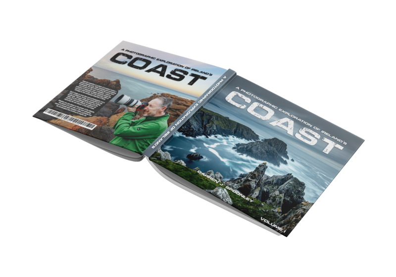 Two issues of COAST magazine displayed at an angle, showing cover photography of outdoor landscapes