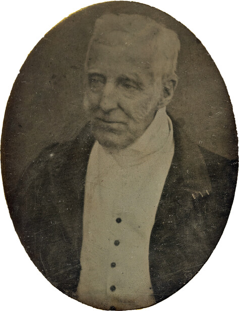Vintage oval portrait photograph of a man in formal attire with high collar