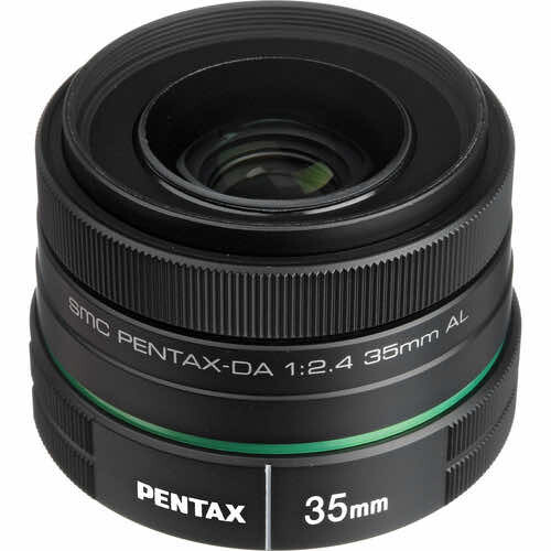Pentax SMC Pentax-DA 35mm f/1:2.4 lens with green accent ring on black background