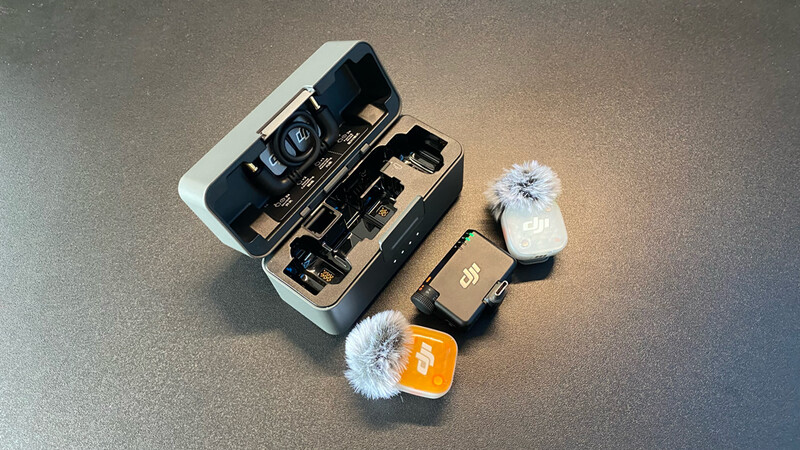 DJI drone and wireless microphone system with wind protection displayed in organized cases