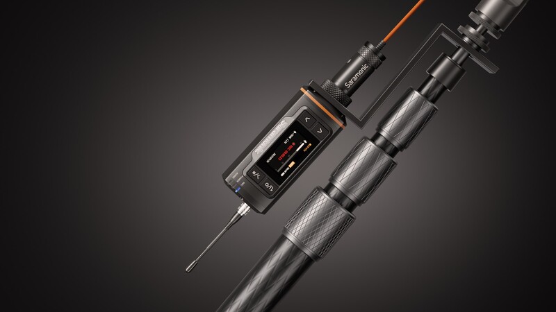 Professional wireless microphone system with transmitter pack and lavalier microphone against dark background
