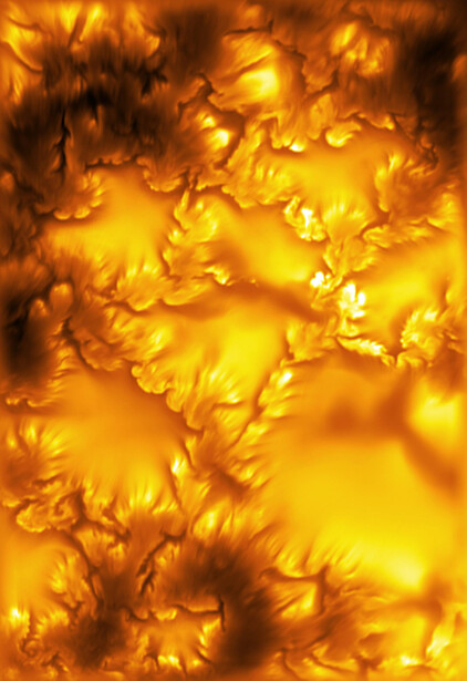 Abstract macro photograph of golden-yellow molten or liquid forms with dramatic highlights and shadow detail