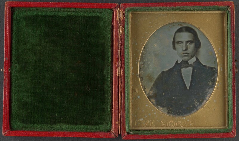 Daguerreotype portrait of a young man in formal 19th-century attire within a red leather case
