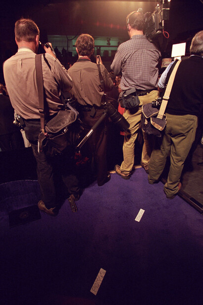 Behind-the-scenes view of a film or video production set with crew members operating camera equipment