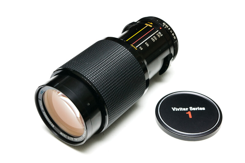 Vivitar Series 1 telephoto lens with front lens cap displayed against white background