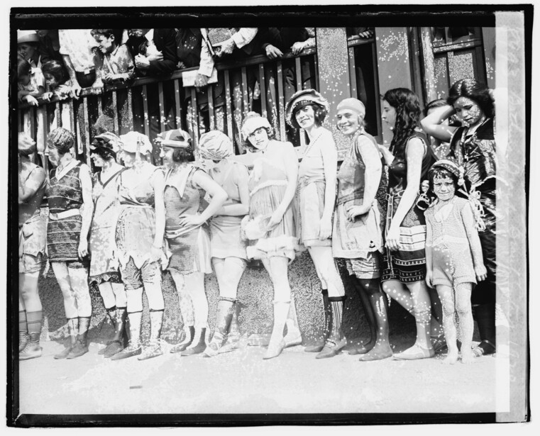 Large group of people standing together on a street, circa early 20th century