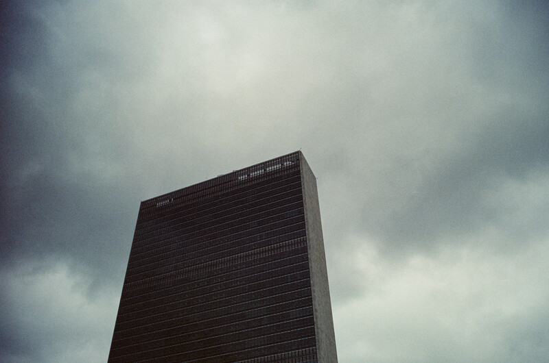 Modern high-rise building silhouetted against overcast grey sky