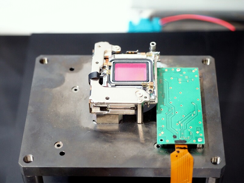 The five-axis stabilization unit lifted out of an Olympus OM-D E-M1