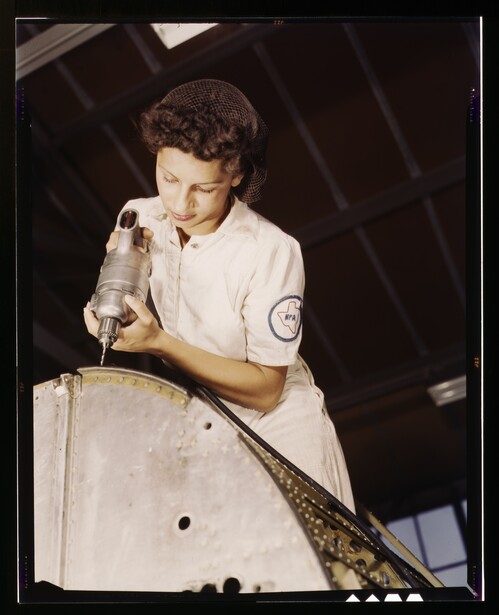 Oyida Peaks, a National Youth Administration trainee at the naval air base in Corpus Christi, Texas, drilling an aircraft panel in August 1942, five months after the Alameda frames were shot