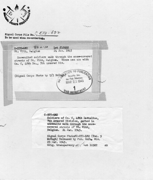 The back of a press print from January 1945, in this case a US Army Signal Corps photograph rather than an Acme one: the agency stamp at top, the file number to quote when reordering, a typed caption slip pasted across the middle, a second slip carry