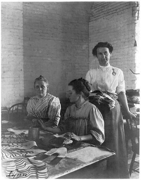 Three women working inside a shoe factory in Lynn, Massachusetts, photographed by Frances Benjamin Johnston; the Library of Congress caption card carries no date