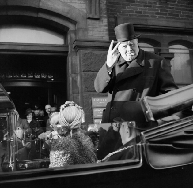 Winston Churchill flashing the two-finger V-for-Victory sign, palm outward, during a visit to Bradford in 1942
