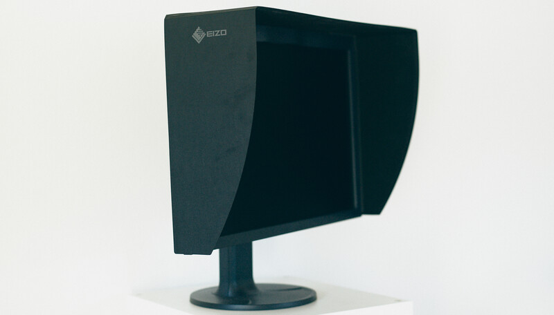 EIZO professional monitor with integrated lens hood displayed against neutral background