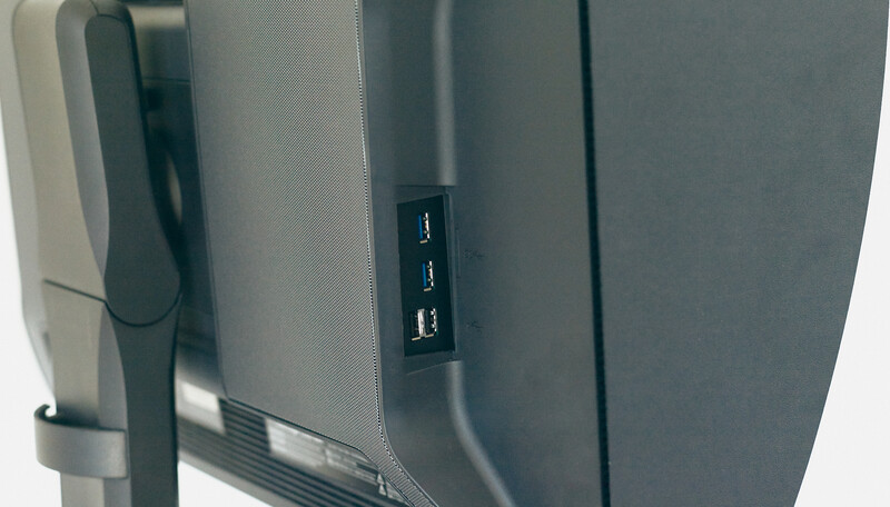 Close-up of monitor back panel showing USB ports and cable connections
