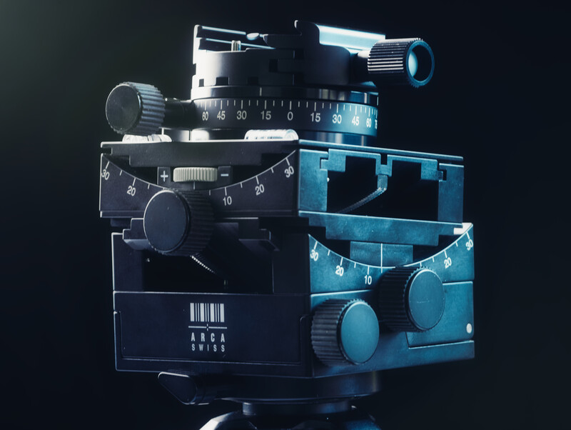 Illustration of stacked cinema camera components with technical schematics and blue accent lighting