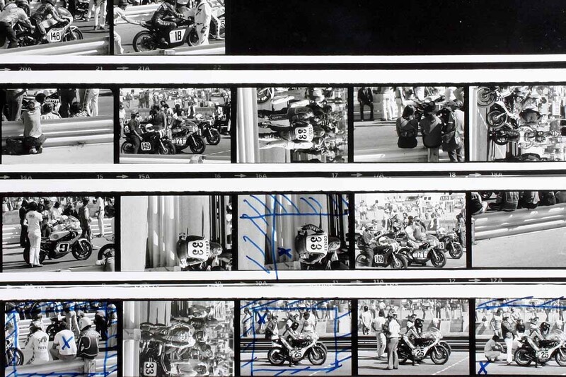 A 35mm black-and-white contact sheet marked up by hand, rejected frames struck through in chinagraph pencil