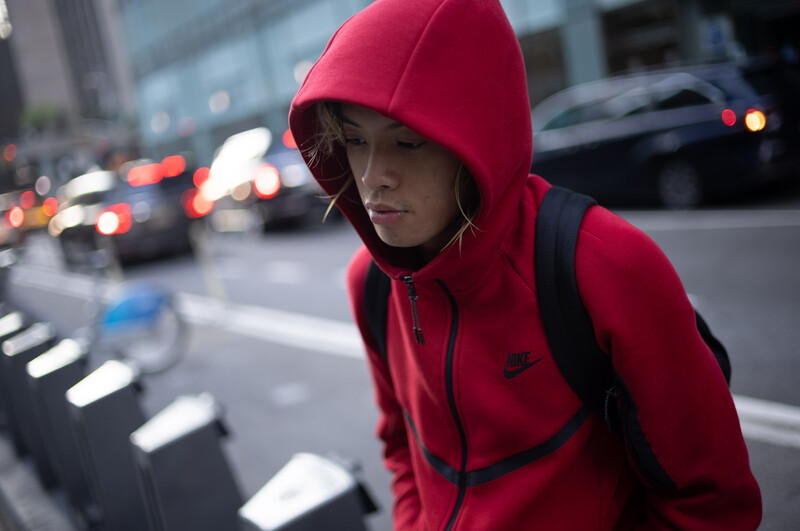 Man wearing hooded sweatshirt looking down