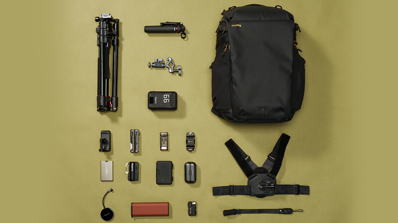 Flat lay of camera gear and accessories arranged on yellow background