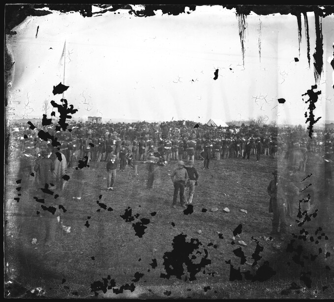 Gardner shot the ceremony on a 4 by 10 inch wet collodion stereograph negative; this is the left half of it, with the flagpole and the crowd spread across the field