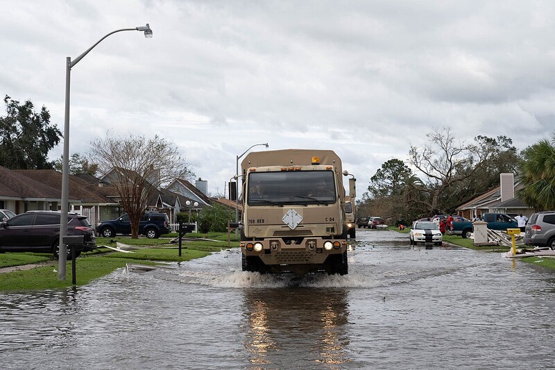 Louisiana National Guard members run a high-water vehicle through St