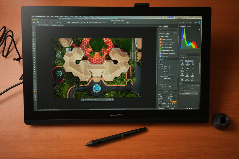 Wacom pen display showing aerial architectural rendering in Adobe Photoshop with histogram and layers panel visible