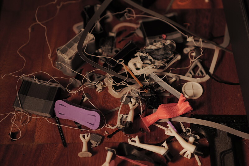 Overhead view of disassembled camera equipment and electronic components on wooden surface