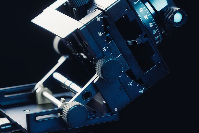 Close-up of a professional cinema camera with numbered focus wheel and manual controls