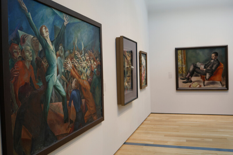 Gallery interior with Renaissance and classical paintings displayed on white walls with wooden flooring