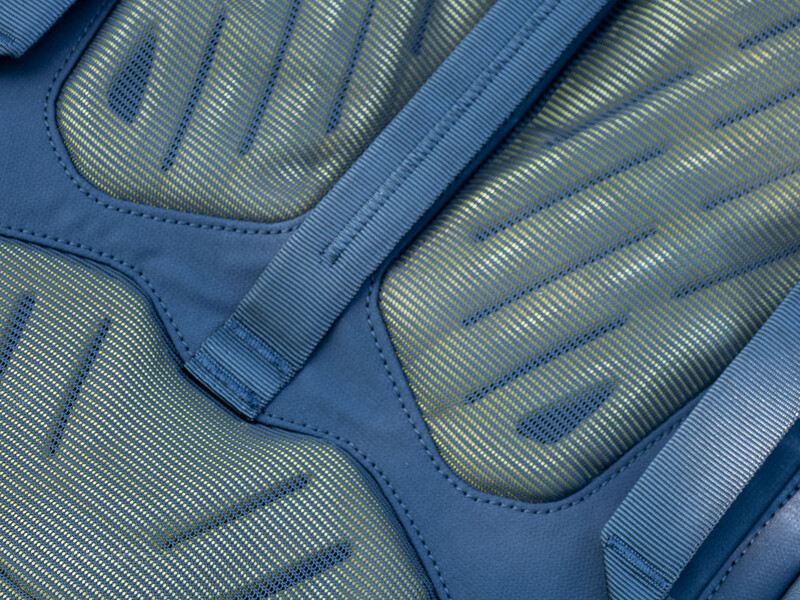 Close-up of blue and gray padded gloves showing textured ribbed fabric and stitched details