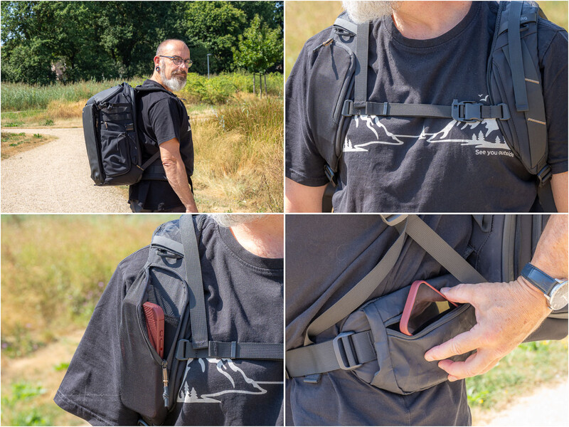 Man wearing black backpack with multiple compartments and straps in outdoor setting