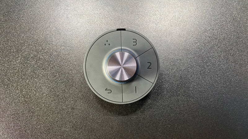 Round dial control with numbered settings 1-5 and central metallic knob on textured surface