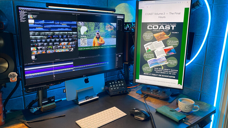 Video editing workstation with dual monitors displaying timeline and footage in professional editing software