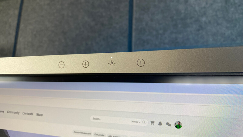 Screenshot showing control icons on a monitor bezel including minus, plus, brightness, and info buttons